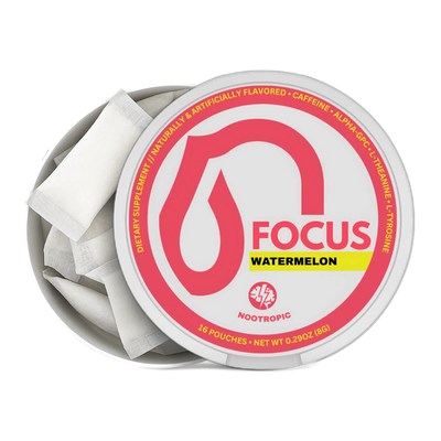 An open round metal tin of Nootropics Focus Watermelon dietary supplement, showing white single-serve pouches inside. The lid features a white label with a prominent pink droplet logo, the word 'FOCUS' in pink, a yellow 'WATERMELON' banner, and the Nootropics logo at the bottom.
